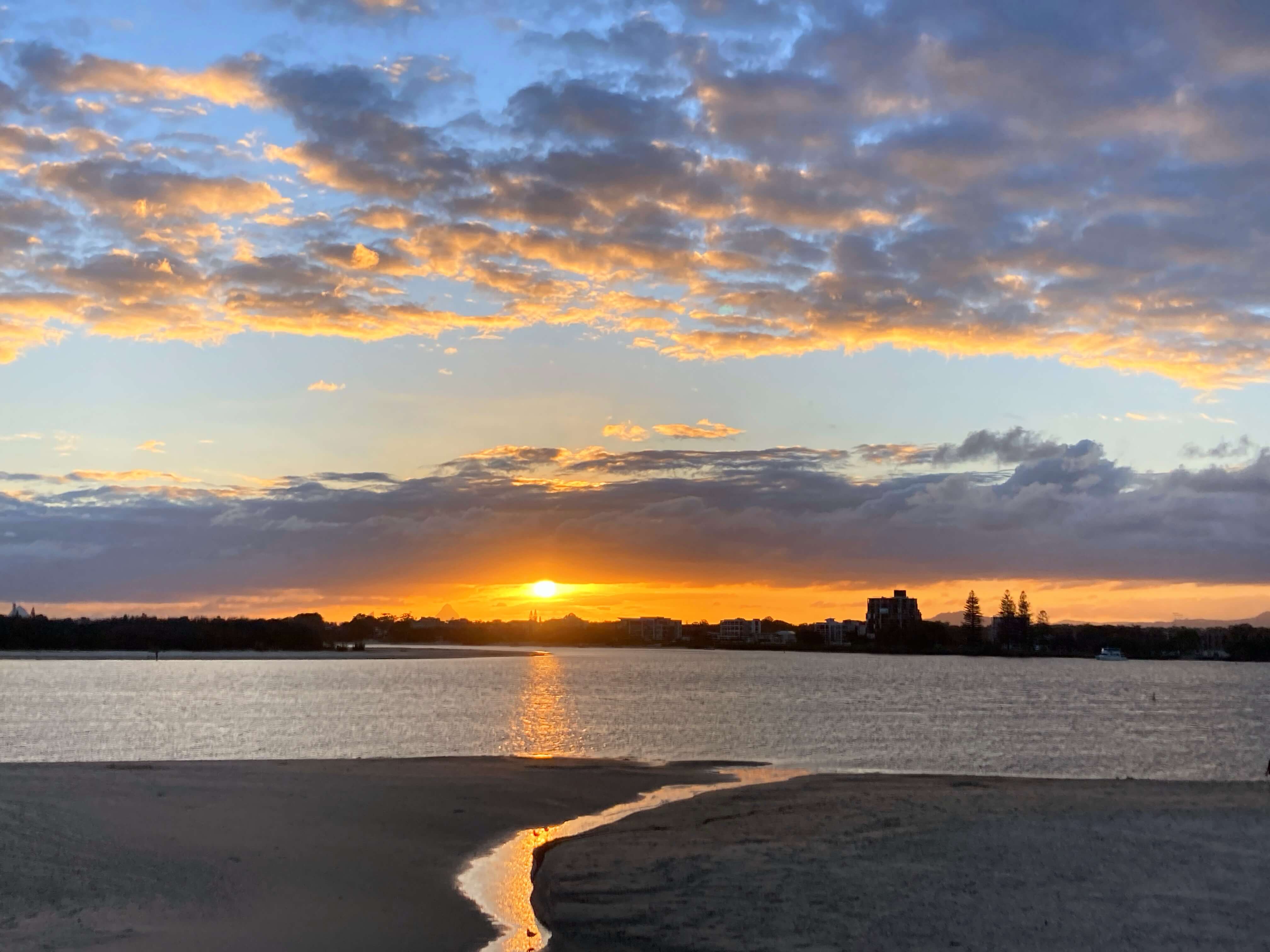 Beach at sunset with town in background Beach at sunset with town in background