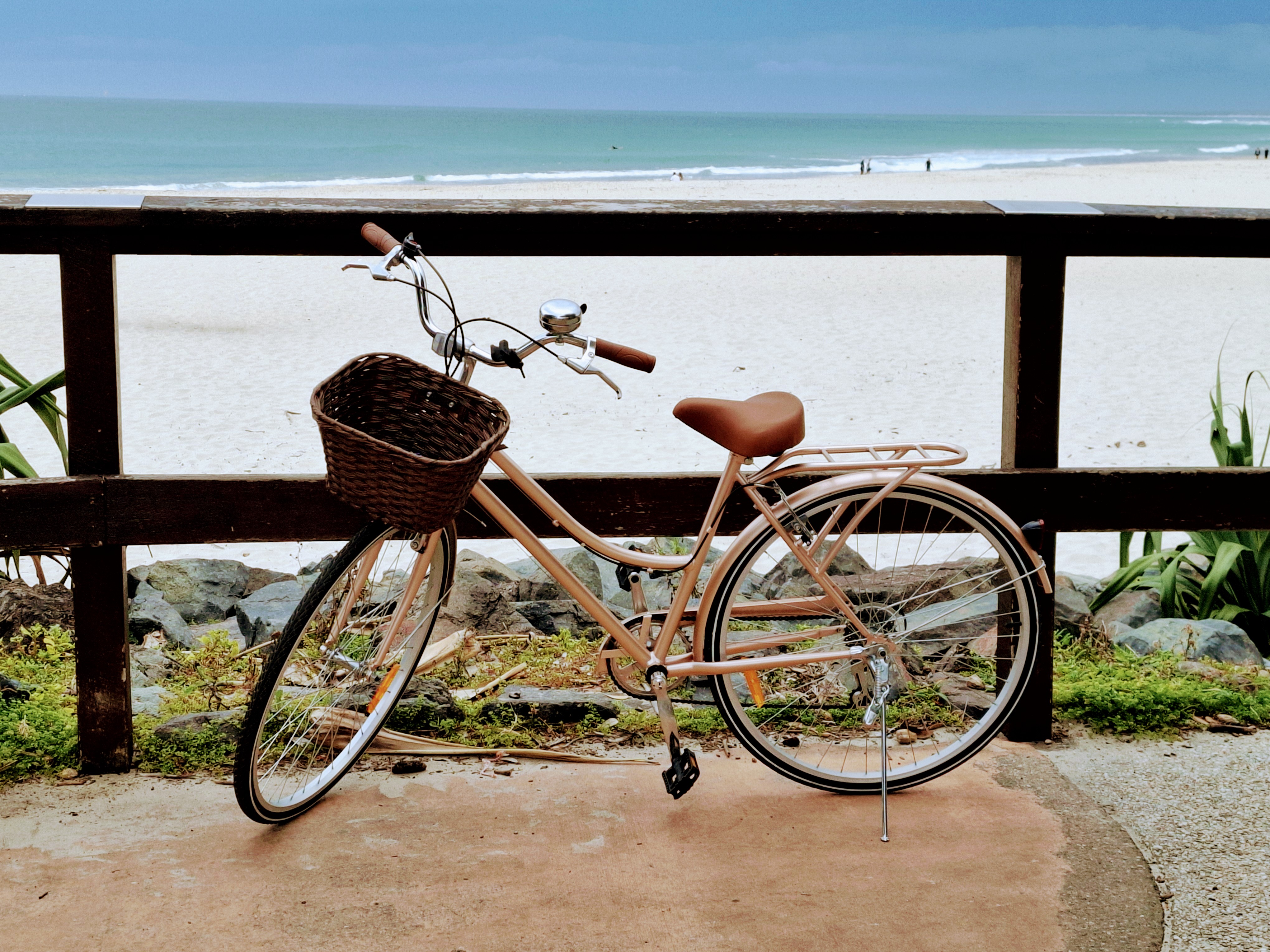 biked parked at beach sea in background biked parked at beach sea in background