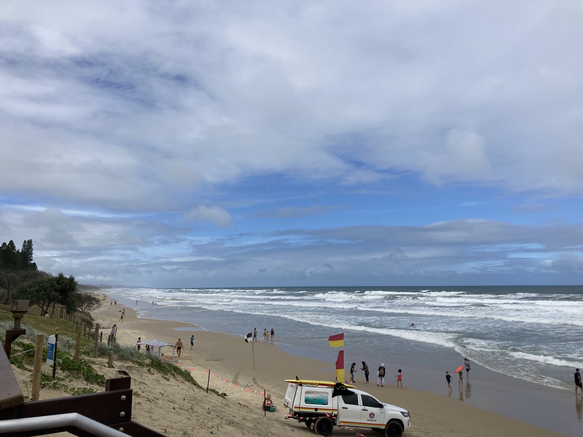 people playing in wave on Coolum Beach Australia people playing in wave on Coolum Beach Australia