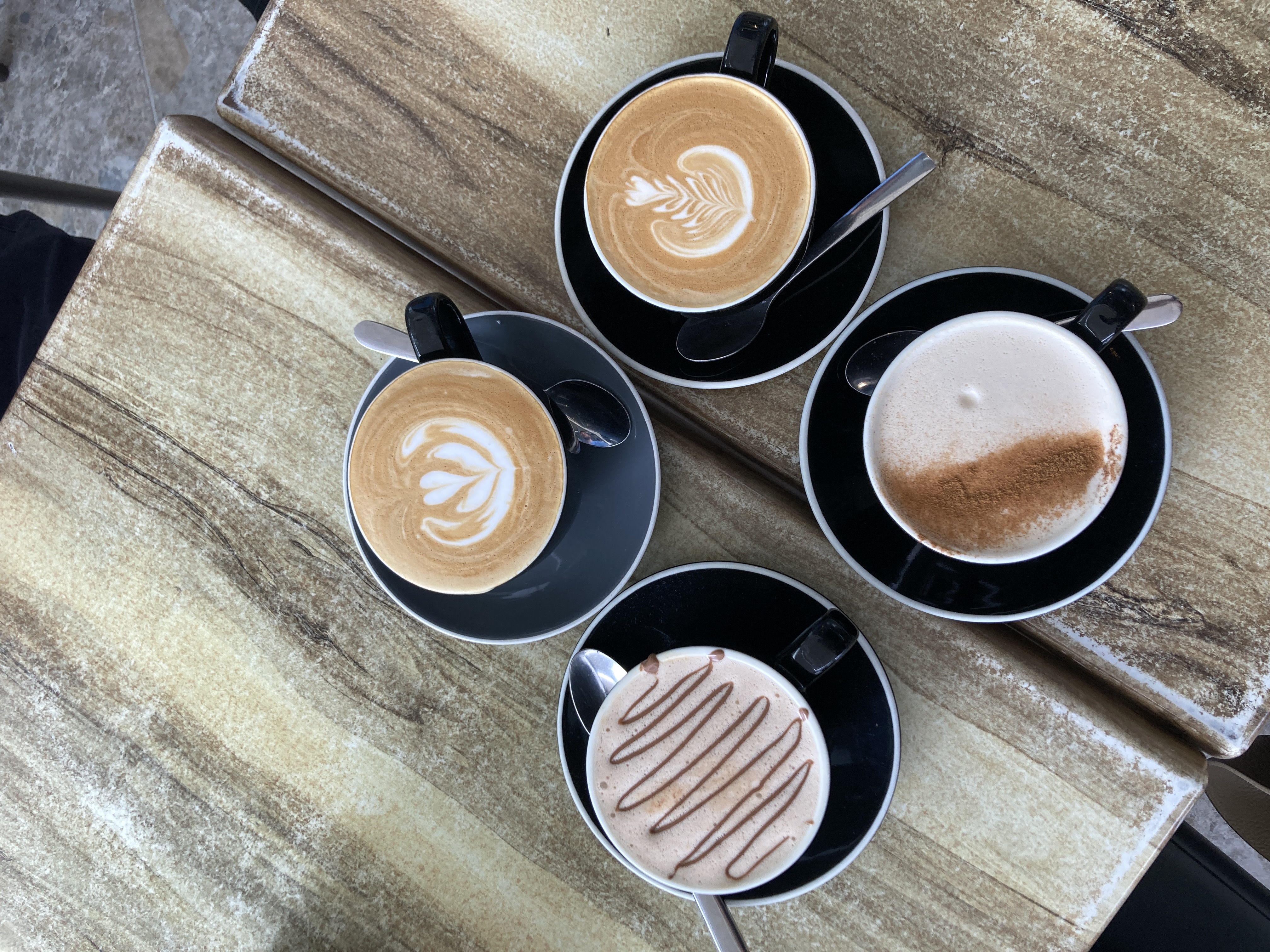 four cups of coffee with coffee art four cups of coffee with coffee art