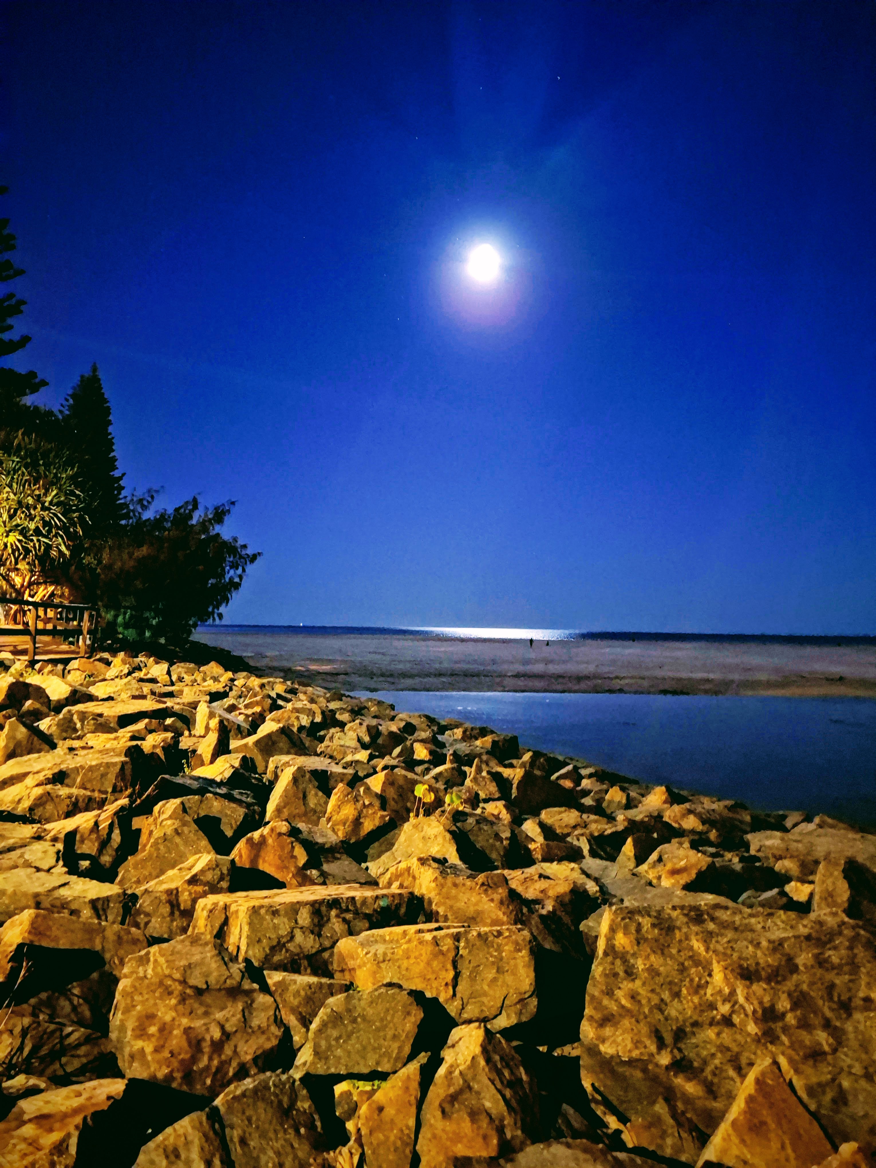 full moon over rocks and beach/sea full moon over rocks and beach/sea