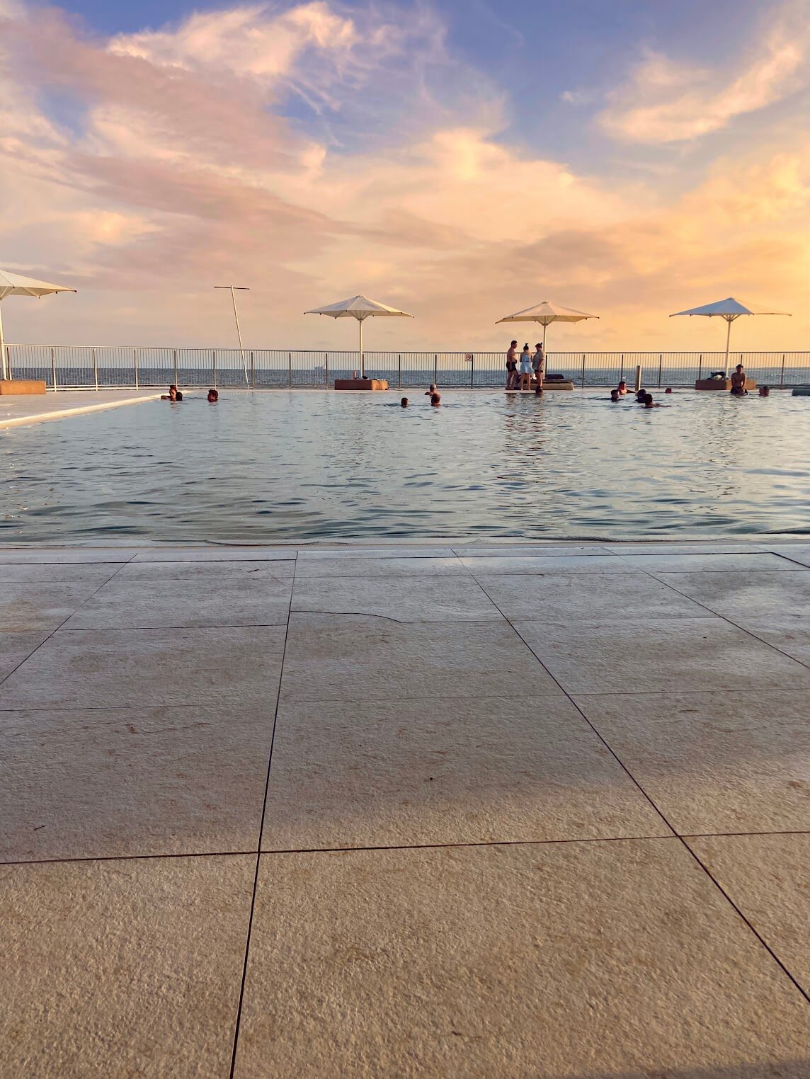 Salt water pool overlooking the ocean at sunset