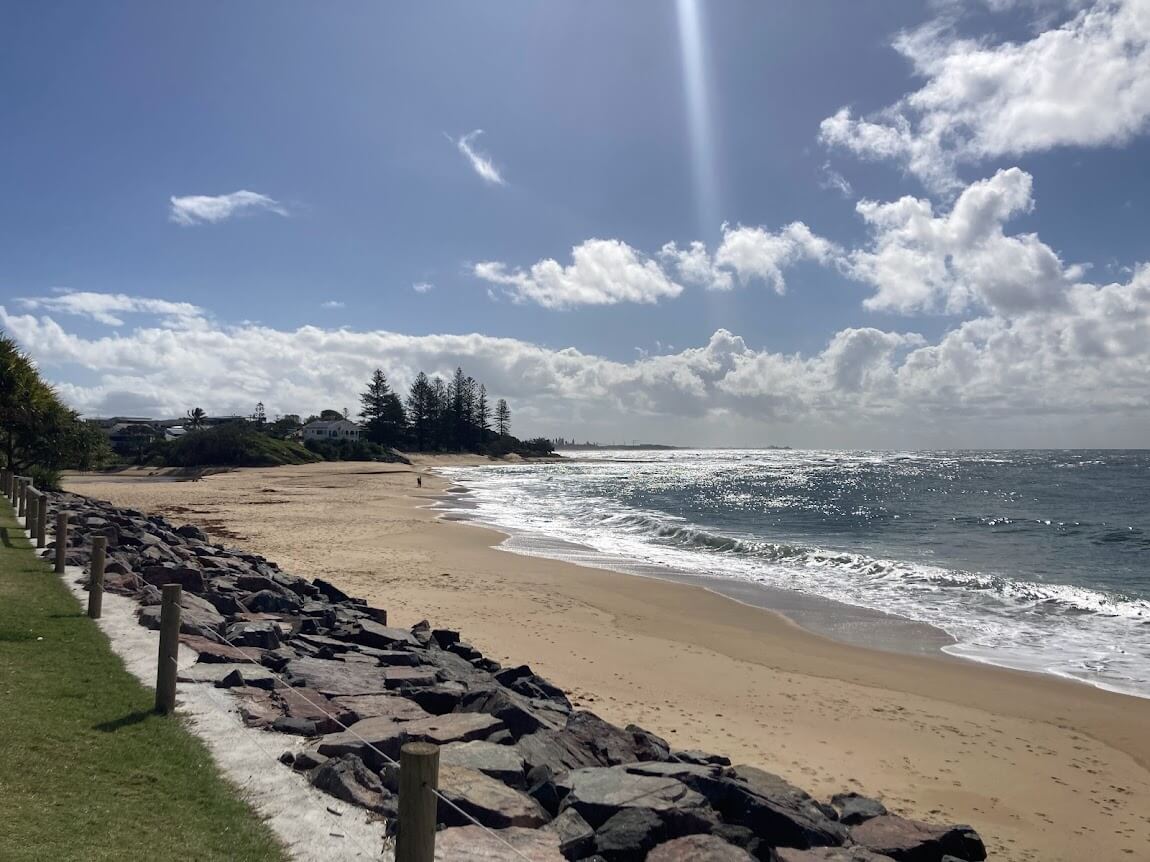 empty beach in winter. Lots of open space with sand. Water is on the right