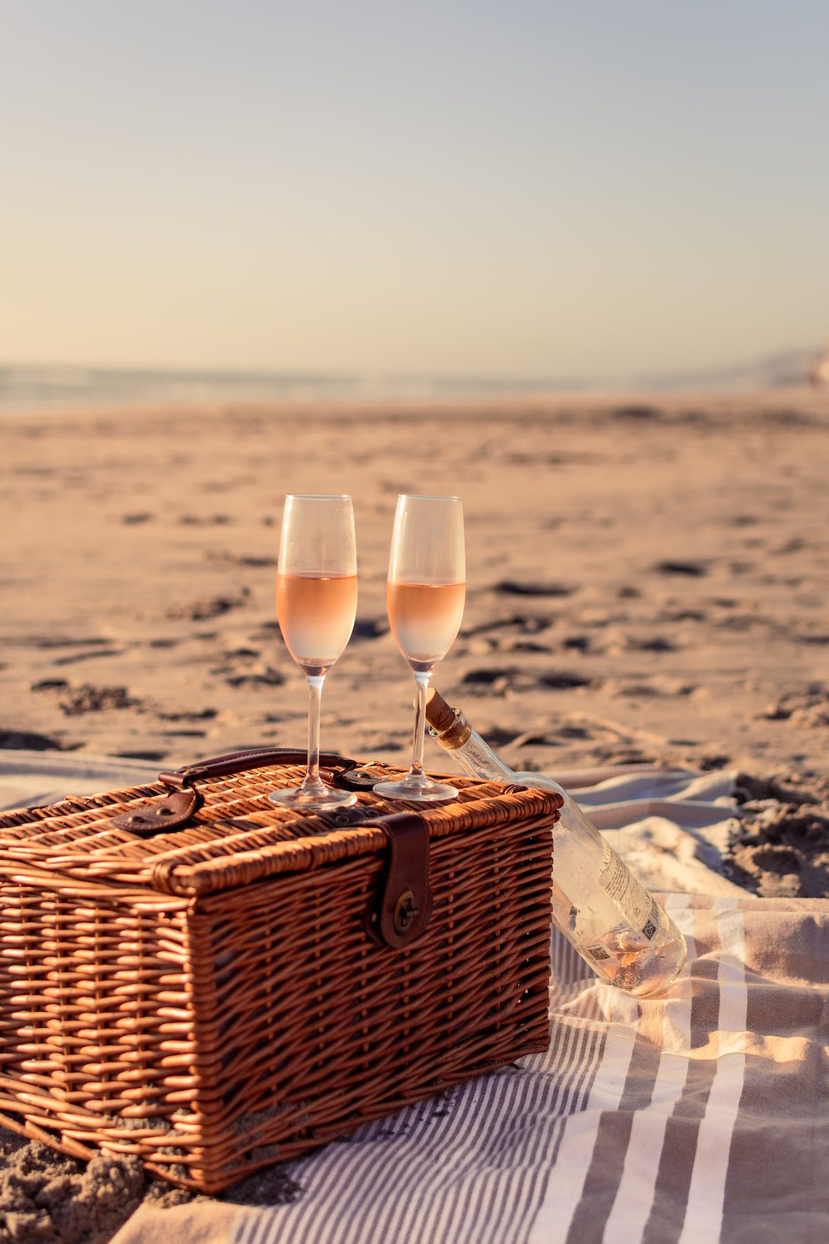 picnic basket and wine on beach picnic basket and wine on beach